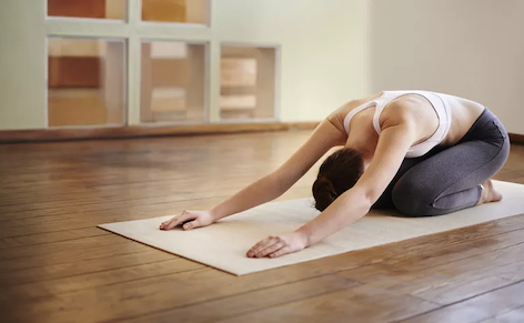 Woman doing yoga on floor